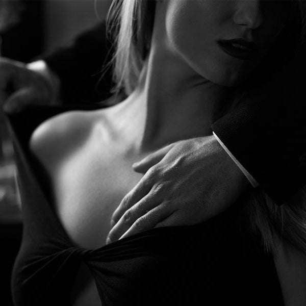 man caressing woman's shoulders, erotica