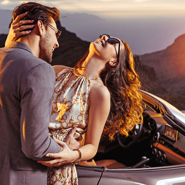 man embracing woman next to convertible, erotic story, another man