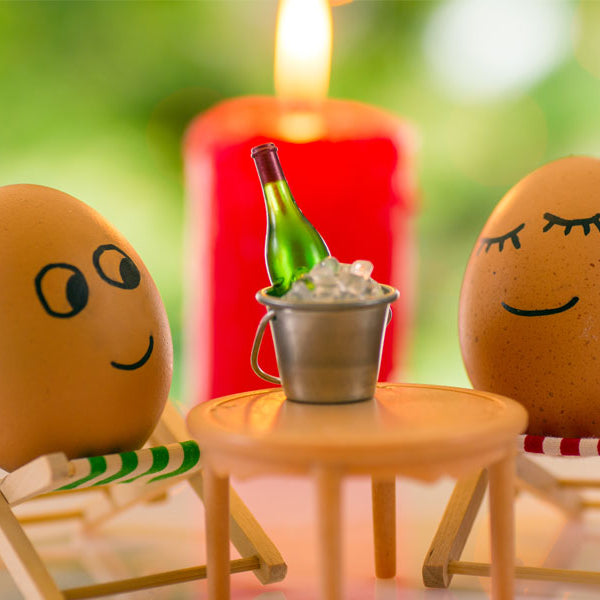 Egg puppet couple enjoying champagne romantic
