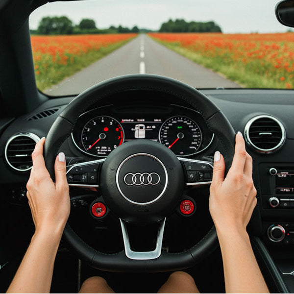 woman's hands on steering wheel of car