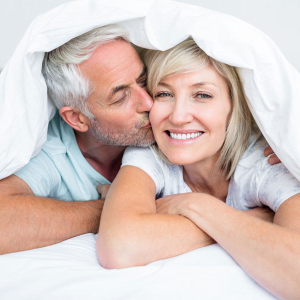older couple under sheets in bed, erectile dysfunction story