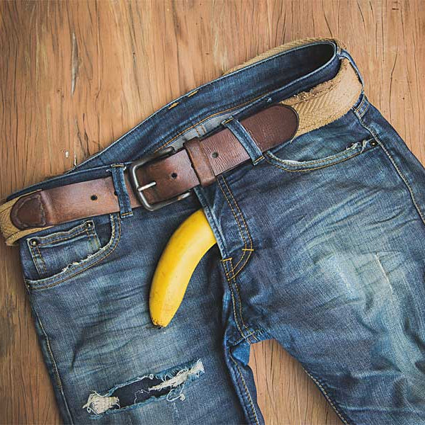 jeans on floor with banana, male castration