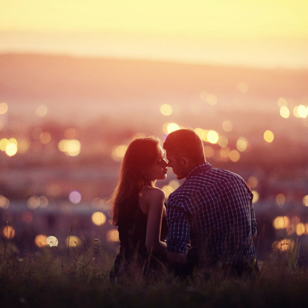 couple kissing in field overlooking city, erotic story