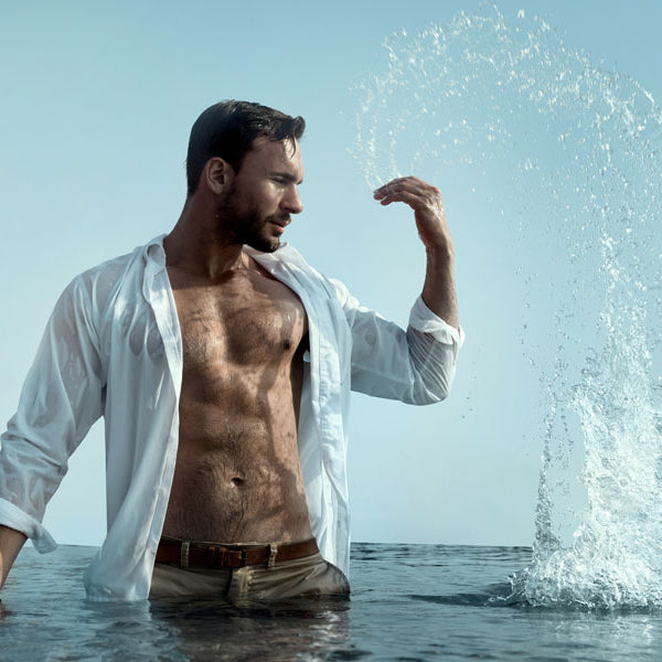 man splashing water in lake, shirt open, skinny dipping story