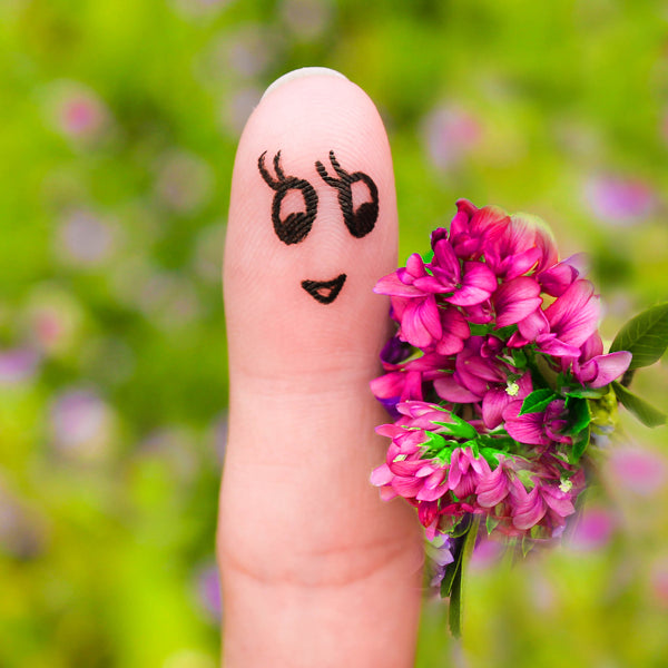 finger puppet female holding bouquet of flowers